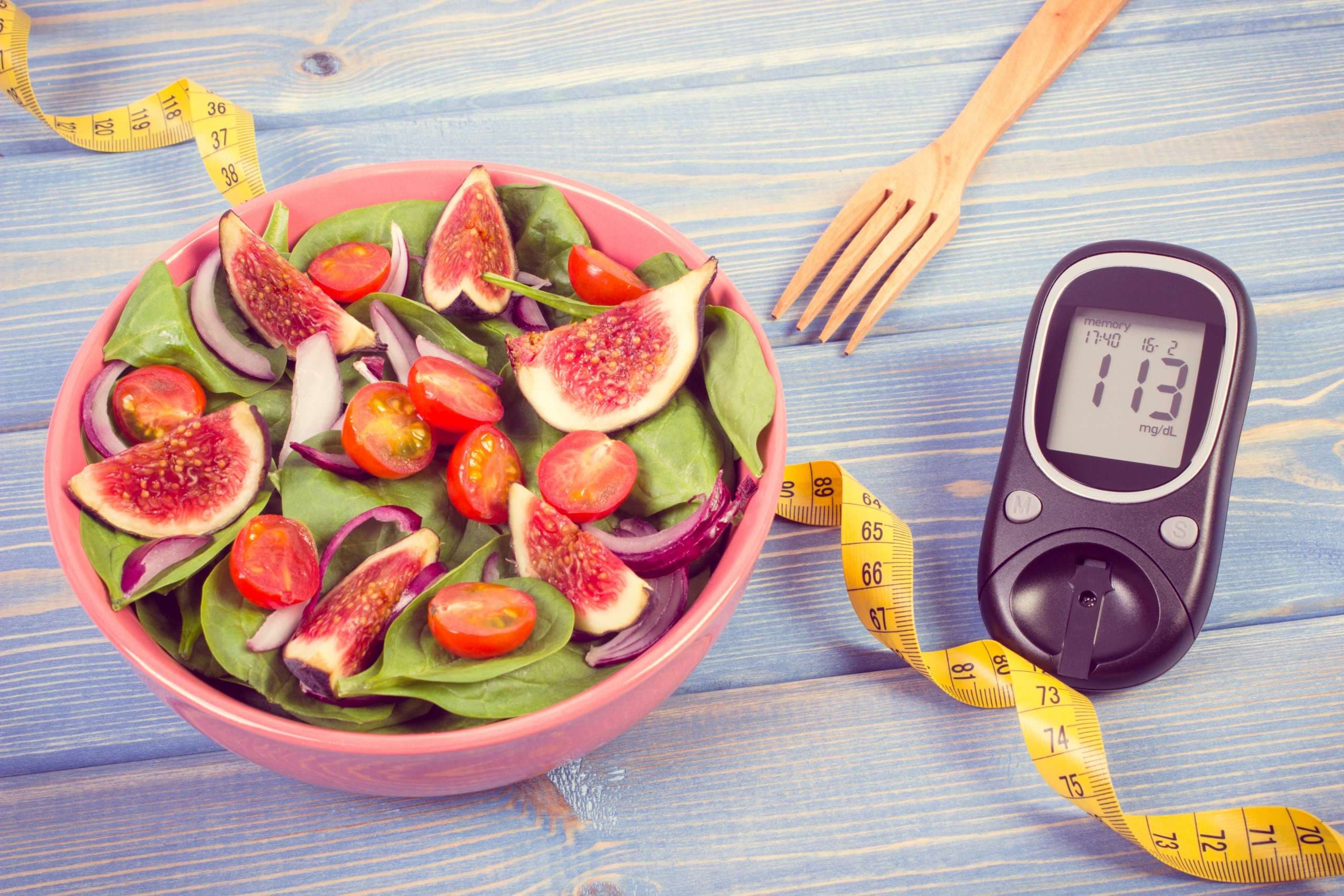 Vintage photo, Fruit and vegetable salad and glucometer with tape measure, concept of diabetes, slimming and healthy nutrition