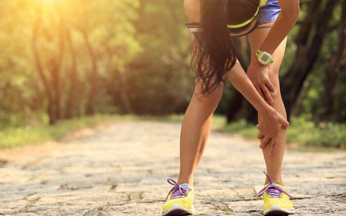 woman runner hold her sports injured knee
